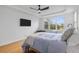 Bright bedroom features a tray ceiling, a ceiling fan, a large window and a television at 228 Beresford Creek St, Charleston, SC 29492