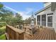 Expansive deck features a dining table, seating, and screened-in porch with picturesque views at 228 Beresford Creek St, Charleston, SC 29492