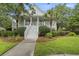 Attractive two-story home boasting a classic porch, lush green lawn, and a neatly landscaped garden at 228 Beresford Creek St, Charleston, SC 29492