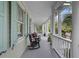 Inviting front porch with rocking chairs and elegant columns, perfect for relaxation and enjoying the view at 228 Beresford Creek St, Charleston, SC 29492