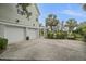 Spacious two-car garage featuring a well-kept driveway, ample parking, and side-yard landscape at 228 Beresford Creek St, Charleston, SC 29492