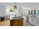 Bright kitchen with a wooden island, gas stovetop, and white cabinetry at 228 Beresford Creek St, Charleston, SC 29492