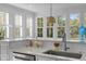 Modern kitchen with a large window, white countertops, and pendant lighting at 228 Beresford Creek St, Charleston, SC 29492