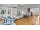Bright living room boasts hardwood floors, built-in shelving, stylish seating and a staircase in an open floor plan at 228 Beresford Creek St, Charleston, SC 29492