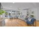 Inviting living room featuring hardwood floors, built-in shelving, and large windows at 228 Beresford Creek St, Charleston, SC 29492