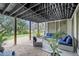 Covered outdoor living space with comfortable seating and views of the landscaped yard at 228 Beresford Creek St, Charleston, SC 29492