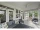 Screened-in porch featuring a ceiling fan, comfortable furniture, and an outdoor patio space at 228 Beresford Creek St, Charleston, SC 29492