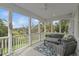 Screened-in porch with comfortable seating, blue patterned rug, and views of nature at 228 Beresford Creek St, Charleston, SC 29492