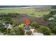 Aerial view of a house with a red pin on top surrounded by trees and a waterfront view at 2369 Rice Pond Rd, Charleston, SC 29414