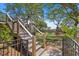 Stairway leads to a lush backyard and spacious elevated deck and outdoor living space at 2369 Rice Pond Rd, Charleston, SC 29414