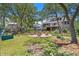 Expansive backyard features lush lawn, mature trees, a firepit, and play area at 2369 Rice Pond Rd, Charleston, SC 29414