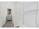 Bright bathroom features neutral gray vanity, tiled floors, and a large glass-enclosed shower and tub combo at 2369 Rice Pond Rd, Charleston, SC 29414