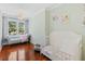 Bedroom featuring wood floors, chaise lounge, and plenty of natural light from the windows at 2369 Rice Pond Rd, Charleston, SC 29414