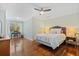 Bright bedroom features hardwood floors, a ceiling fan, and a cozy window-side desk and chair at 2369 Rice Pond Rd, Charleston, SC 29414