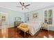 Bright bedroom featuring hardwood floors, ceiling fan, and comfortable furniture at 2369 Rice Pond Rd, Charleston, SC 29414