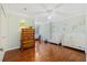 Bright bedroom featuring hardwood floors, a ceiling fan, and two white toddler beds at 2369 Rice Pond Rd, Charleston, SC 29414