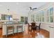 Bright breakfast nook features an island with seating and multiple windows and a breakfast table at 2369 Rice Pond Rd, Charleston, SC 29414
