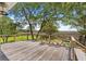 Spacious wooden deck offers beautiful views of the marsh and backyard area with seating at 2369 Rice Pond Rd, Charleston, SC 29414