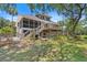 Stunning rear exterior of house with multiple decks and screened porches overlooking gorgeous lawn at 2369 Rice Pond Rd, Charleston, SC 29414