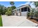 Exterior of house showing garages, and a screened in porch with a basketball hoop and wide driveway at 2369 Rice Pond Rd, Charleston, SC 29414