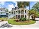 Stunning two-story home with an inviting porch, manicured landscaping, and a circular driveway at 2369 Rice Pond Rd, Charleston, SC 29414