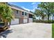House exterior showing a three-car garage and a screened porch with a basketball hoop at 2369 Rice Pond Rd, Charleston, SC 29414
