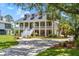 Stately home with a welcoming front porch, manicured landscaping, and ample parking on a circular driveway at 2369 Rice Pond Rd, Charleston, SC 29414
