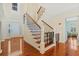 Grand foyer with hardwood floors, a staircase with iron balusters, and abundant natural light at 2369 Rice Pond Rd, Charleston, SC 29414