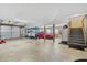 Spacious garage with ample storage, featuring a parked car, kayaks, and stairs to upper floor at 2369 Rice Pond Rd, Charleston, SC 29414
