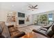 Spacious living room featuring hardwood floors, fireplace, built-in shelving and backyard view at 2369 Rice Pond Rd, Charleston, SC 29414