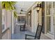 Relaxing porch with rocking chairs, black shutters, ceiling fans, and decorative sconces at 2369 Rice Pond Rd, Charleston, SC 29414