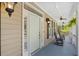 Inviting porch featuring a white door, black shutters, and rocking chairs, perfect for relaxing outdoors at 2369 Rice Pond Rd, Charleston, SC 29414