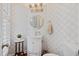 Stylish powder room featuring patterned wallpaper, a vanity with a vessel sink, and modern lighting fixtures at 2369 Rice Pond Rd, Charleston, SC 29414