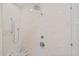 Detail of marble tiled shower featuring multiple shower heads and bench at 2369 Rice Pond Rd, Charleston, SC 29414