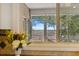 Kitchen window overlooking marsh view with patio and lush green trees at 2369 Rice Pond Rd, Charleston, SC 29414