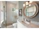 Modern bathroom featuring glass enclosed shower, marble counter, and designer fixtures at 2618 Raven Dr, Sullivans Island, SC 29482