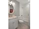 Well-lit bathroom with marble vanity, round mirror, subway tile, and shower-tub combo at 2618 Raven Dr, Sullivans Island, SC 29482