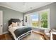 Cozy bedroom bathed in natural light with scenic views, comfortable queen bed, and inviting chair at 2618 Raven Dr, Sullivans Island, SC 29482