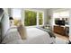 Relaxing bedroom showcasing a large window, comfortable bedding, and scenic views for tranquil living at 2618 Raven Dr, Sullivans Island, SC 29482