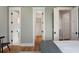 Bedroom with wood floors, three closets, ensuite bathroom, and gray paint at 2618 Raven Dr, Sullivans Island, SC 29482