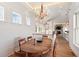 Elegant dining room showcasing a wooden table, chandelier, and views into the home's open living spaces at 2618 Raven Dr, Sullivans Island, SC 29482