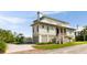 Charming two-story beach home featuring a covered porch, and a well-manicured lawn at 2618 Raven Dr, Sullivans Island, SC 29482
