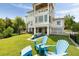 Back of house with a lawn, seating, and pool at 2618 Raven Dr, Sullivans Island, SC 29482