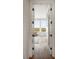 Bright hallway featuring hardwood floors, white shiplap walls and views of the marsh at 2618 Raven Dr, Sullivans Island, SC 29482