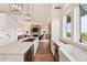 Open-concept kitchen featuring a large island with marble countertops, modern appliances, and seamless flow to living spaces at 2618 Raven Dr, Sullivans Island, SC 29482