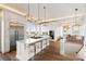 Open kitchen with an island, stainless steel appliances, and hardwood floors at 2618 Raven Dr, Sullivans Island, SC 29482