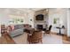 Inviting living room featuring a brick fireplace, comfortable seating, and ample natural light for a cozy ambiance at 2618 Raven Dr, Sullivans Island, SC 29482
