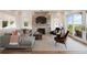 Cozy living room with brick fireplace, plush seating, and expansive windows, creating a warm and inviting atmosphere at 2618 Raven Dr, Sullivans Island, SC 29482
