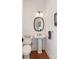 Charming powder room featuring shiplap walls, pedestal sink, and elegant mirror, adding a touch of sophistication at 2618 Raven Dr, Sullivans Island, SC 29482