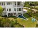 Stunning rear exterior view with pool and outdoor seating on the manicured lawn at 2618 Raven Dr, Sullivans Island, SC 29482